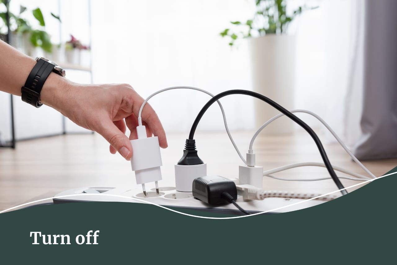 Close up image of a person's hand pulling out a cord plugged in.