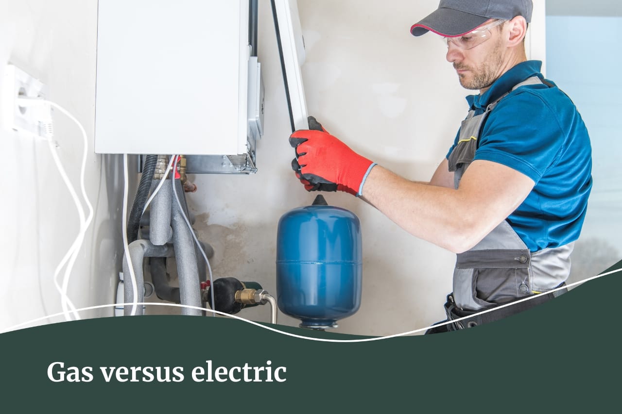 A man in a blue uniform installing a gas heater inside a home.